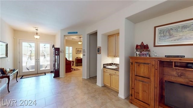 foyer with french doors and ceiling fan