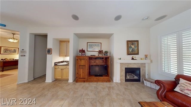 living area featuring a tile fireplace