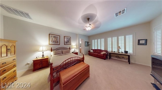 bedroom with visible vents, light carpet, baseboards, and ceiling fan