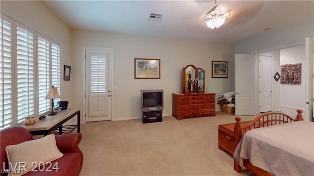 bedroom featuring multiple windows, baseboards, visible vents, and carpet floors