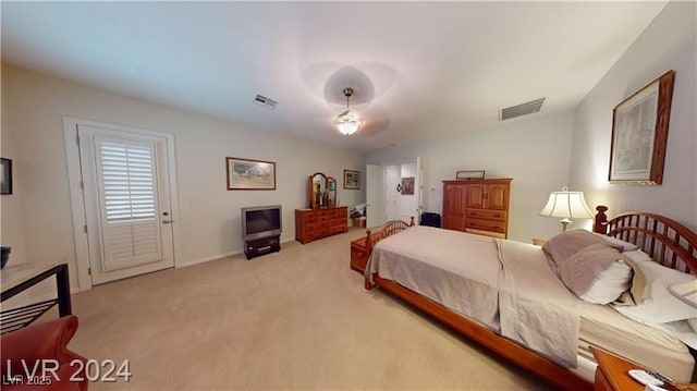 bedroom featuring visible vents and light carpet