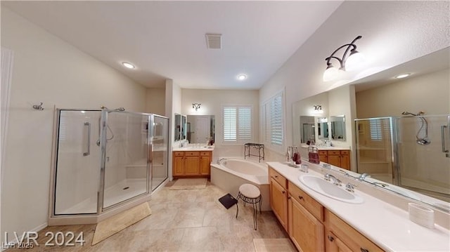 full bath featuring visible vents, a garden tub, two vanities, a stall shower, and a sink