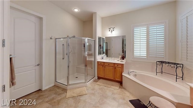 bathroom with a bath, a shower stall, and vanity