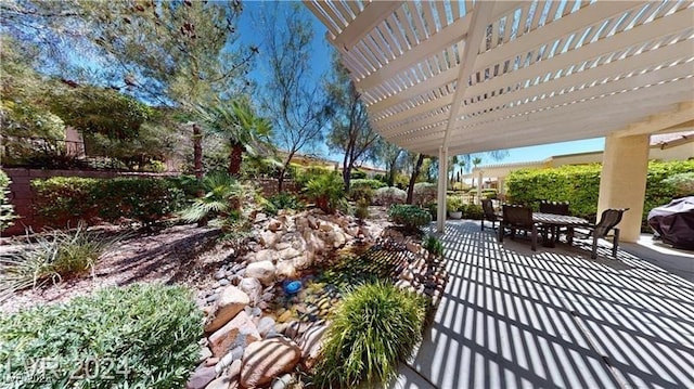 view of patio featuring outdoor dining space and a pergola