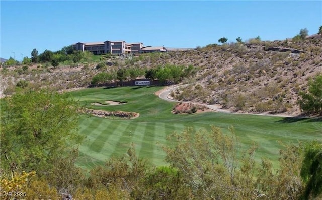 view of home's community featuring a lawn and golf course view