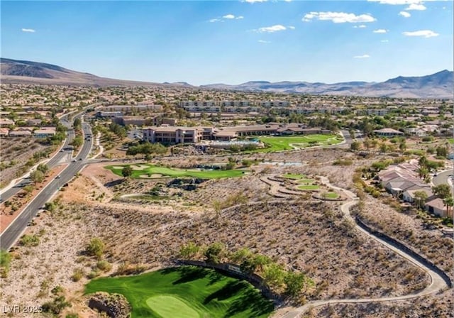 bird's eye view with a mountain view and view of golf course