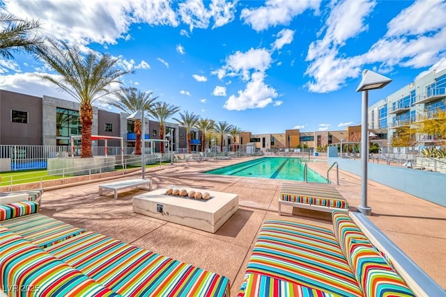 pool with a residential view, an outdoor living space with a fire pit, a patio, and fence