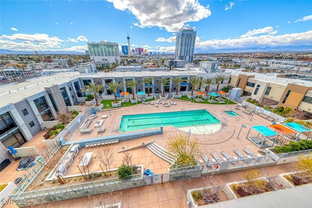 view of pool featuring a patio and a view of city