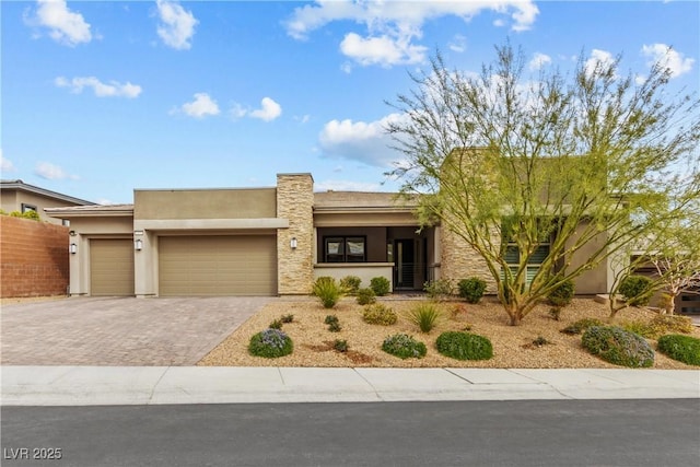 view of front of property with a garage, decorative driveway, fence, and stucco siding