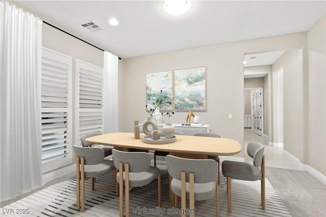 dining room with recessed lighting, baseboards, visible vents, and light colored carpet