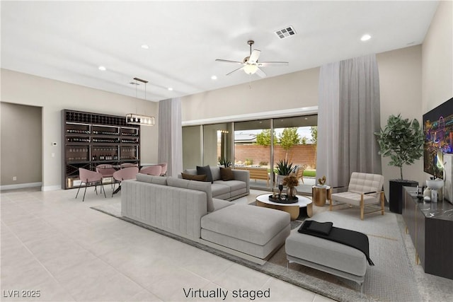 living area featuring baseboards, recessed lighting, visible vents, and ceiling fan