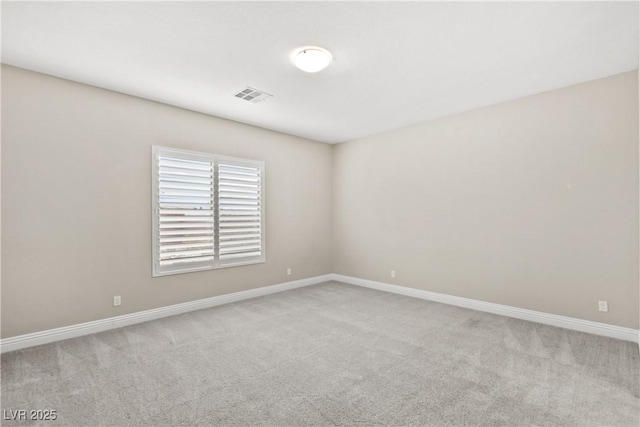 carpeted empty room with visible vents and baseboards