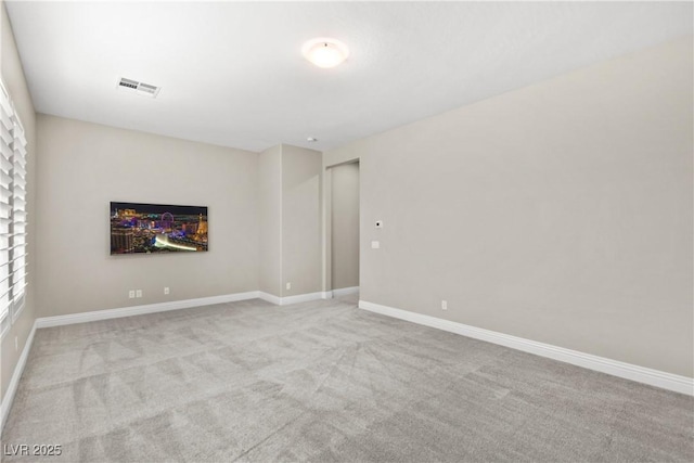 carpeted spare room with baseboards and visible vents