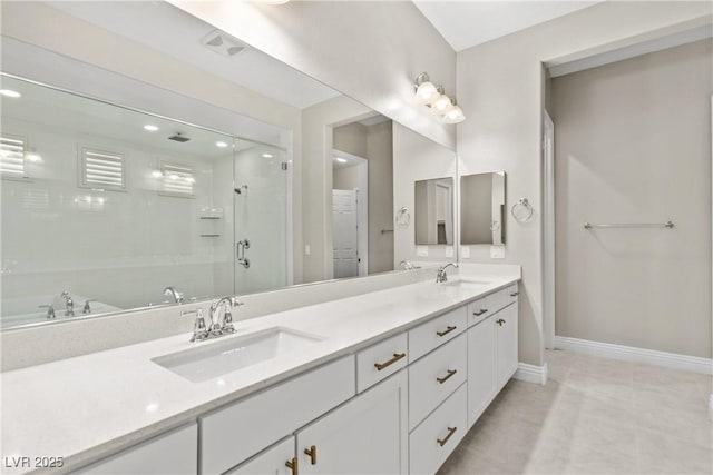 bathroom featuring double vanity, baseboards, a sink, and a stall shower