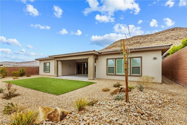 back of property featuring a patio area, a lawn, a fenced backyard, and stucco siding