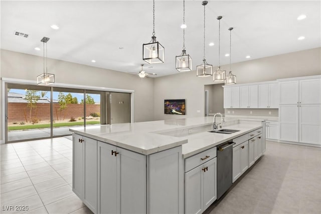 kitchen with visible vents, white cabinetry, a spacious island, a sink, and stainless steel dishwasher