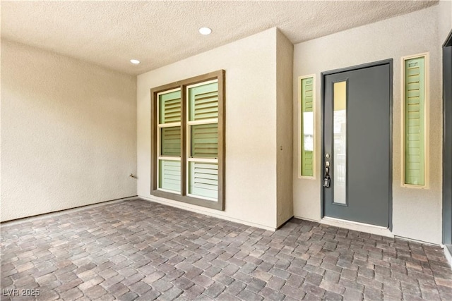 doorway to property with a patio area and stucco siding
