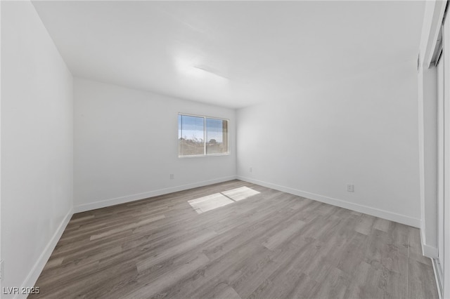 unfurnished bedroom featuring light wood-type flooring and baseboards