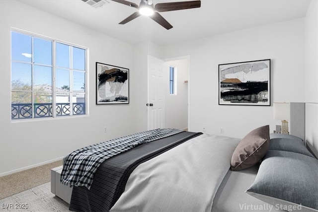 carpeted bedroom featuring visible vents, a ceiling fan, and baseboards