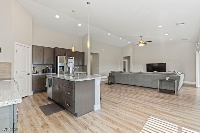 kitchen featuring light wood-type flooring, visible vents, dark brown cabinetry, appliances with stainless steel finishes, and ceiling fan