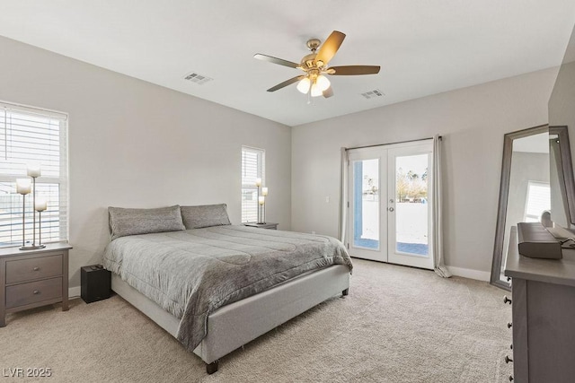 bedroom with access to outside, french doors, visible vents, and light carpet