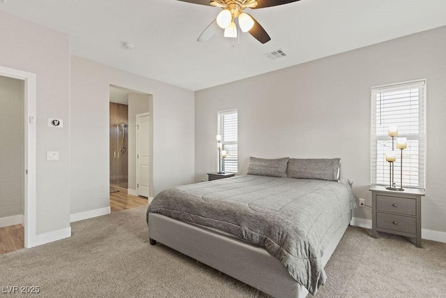 carpeted bedroom with a ceiling fan, baseboards, and visible vents