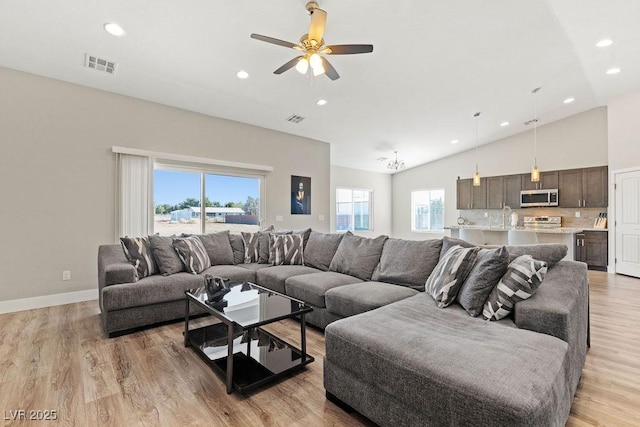 living area featuring recessed lighting, light wood-style floors, visible vents, and baseboards