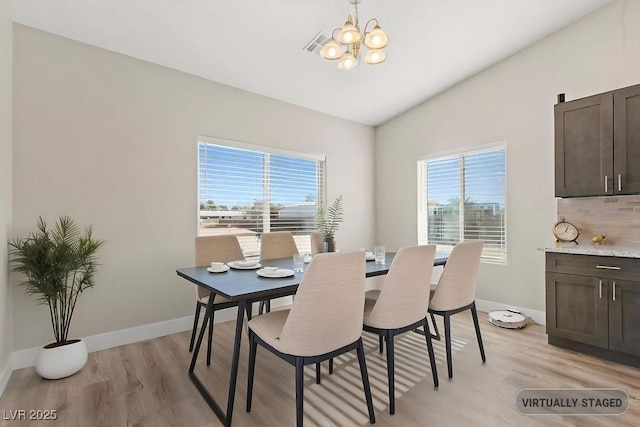 dining area with vaulted ceiling, plenty of natural light, and light wood finished floors