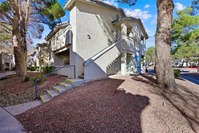 view of property exterior featuring stucco siding and a tile roof