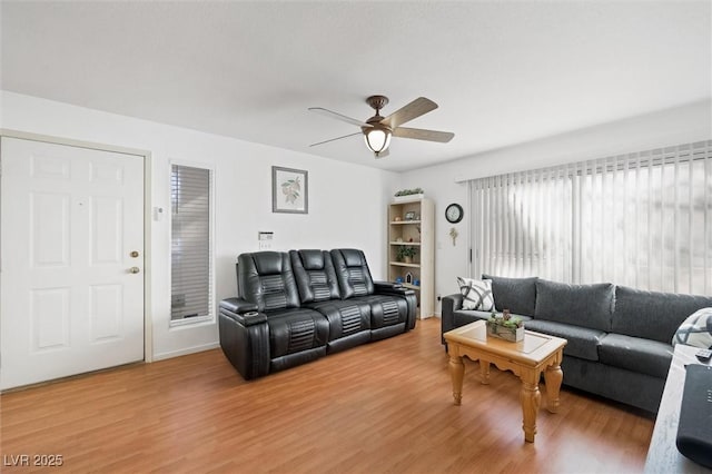 living area with light wood-style floors and ceiling fan