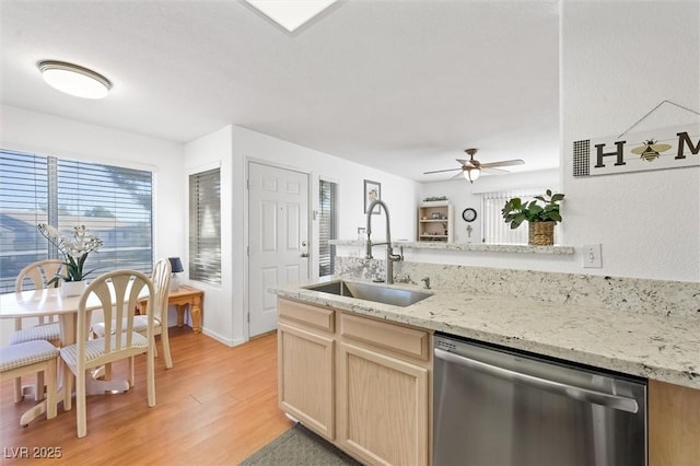 kitchen featuring a ceiling fan, light wood-style flooring, light brown cabinetry, a sink, and stainless steel dishwasher