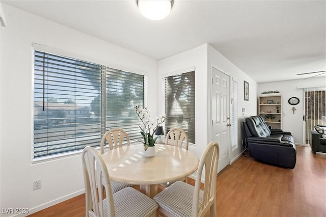 dining room featuring light wood-type flooring and baseboards