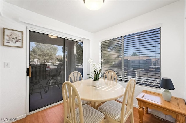 dining area featuring light wood-style floors and baseboards