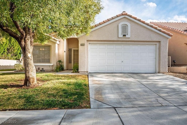 view of front of house with a tile roof, an attached garage, driveway, and stucco siding