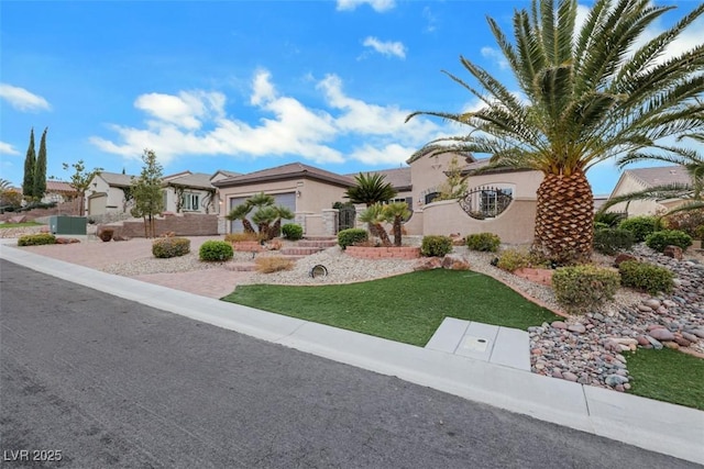 view of front of house featuring stucco siding and a front lawn