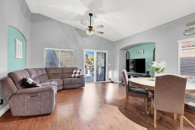 living area with vaulted ceiling, wood finished floors, visible vents, and ceiling fan