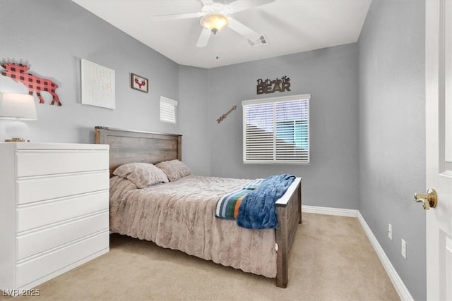 bedroom with visible vents, light colored carpet, a ceiling fan, and baseboards