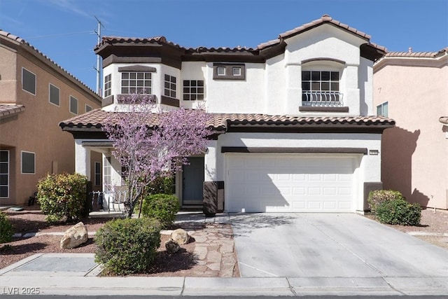 mediterranean / spanish-style house with a tiled roof, an attached garage, driveway, and stucco siding