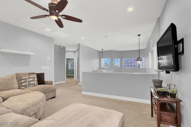 living area with recessed lighting, light colored carpet, baseboards, and ceiling fan