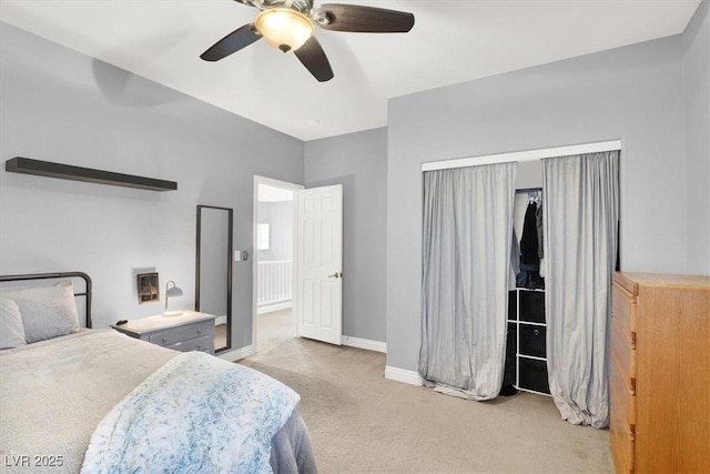 bedroom featuring baseboards, light carpet, and ceiling fan