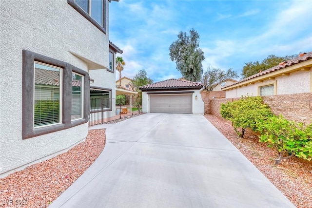 exterior space featuring a garage and fence