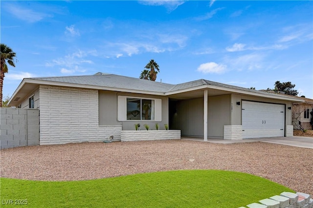 ranch-style house with an attached garage, driveway, a front yard, and fence