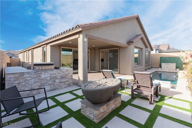 view of patio / terrace featuring an outdoor kitchen, a fenced backyard, and a fenced in pool