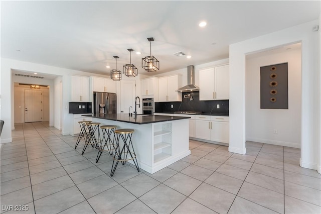 kitchen featuring open shelves, stainless steel appliances, decorative backsplash, dark countertops, and wall chimney range hood