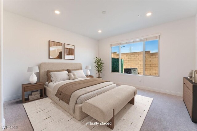 bedroom with recessed lighting, light colored carpet, and baseboards