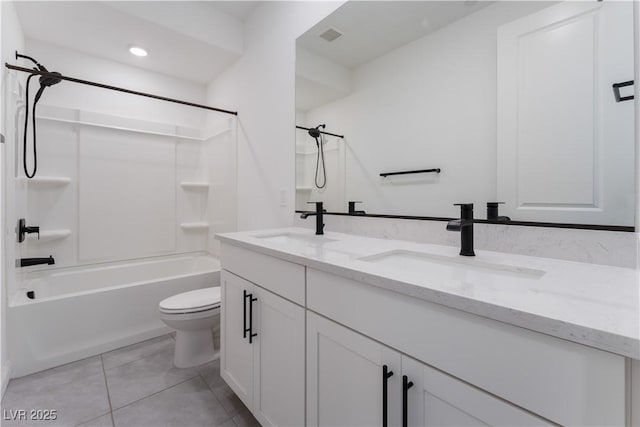 full bathroom featuring a sink, toilet, double vanity, and tile patterned floors