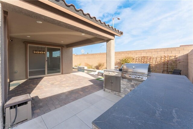 view of patio featuring area for grilling, a grill, and a fenced backyard