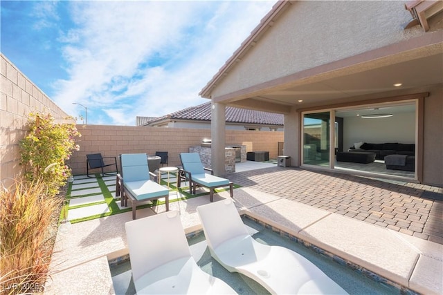 view of patio / terrace with area for grilling and a fenced backyard