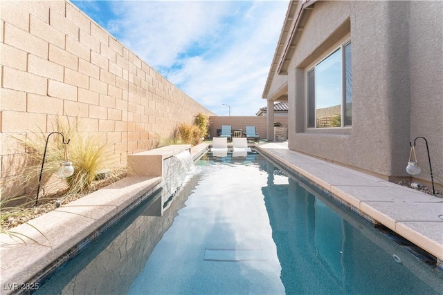 view of swimming pool featuring a patio, a fenced backyard, and a fenced in pool