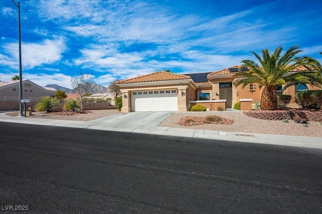 mediterranean / spanish house featuring stucco siding, driveway, an attached garage, solar panels, and a tiled roof